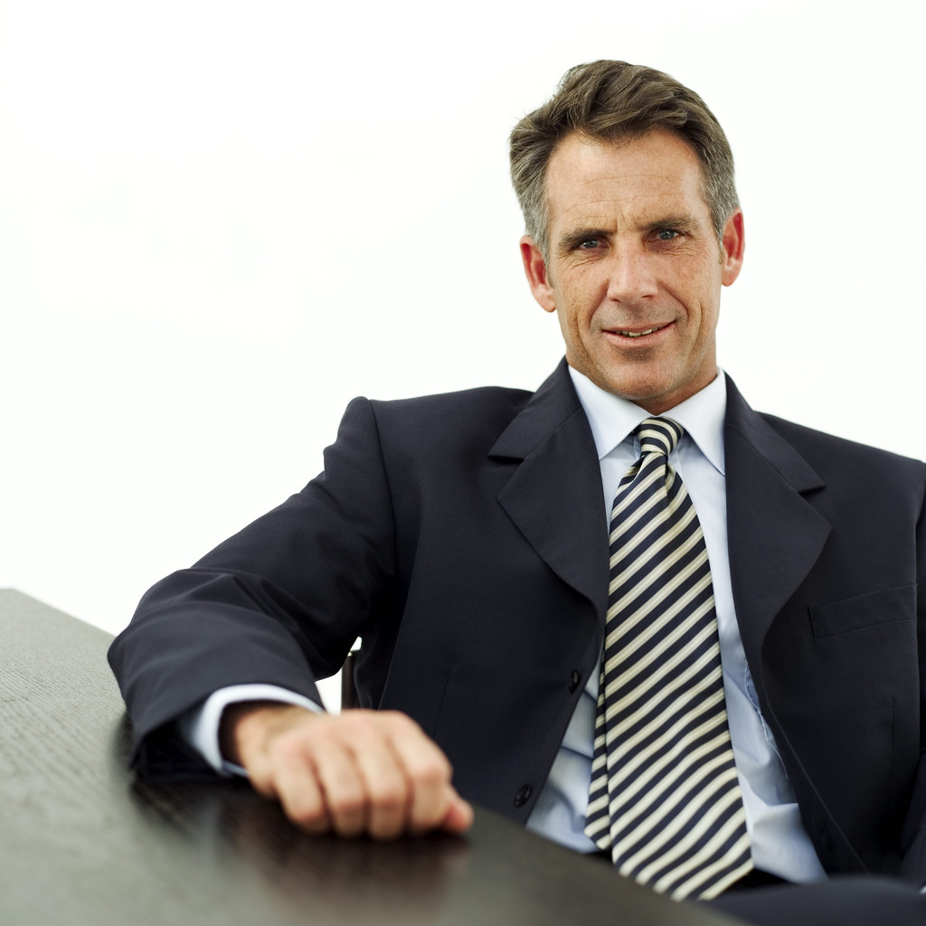 Mature Businessman Seated at a Table