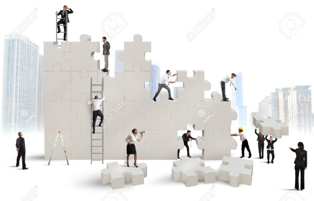 31364187-Business-team-Builds-a-new-company-with-puzzle-Stock-Photo