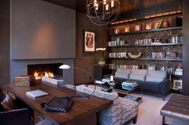 Stylish-home-office-with-plenty-of-shelf-space-and-a-chic-fireplace