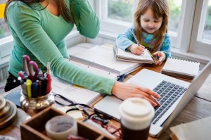 Mother and daughter (4-5) in home office
