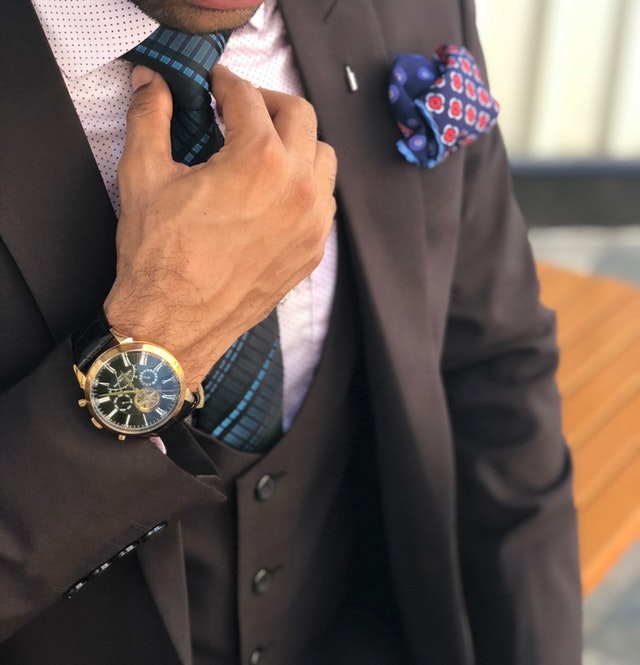 man-in-formal-suit-jacket-holding-his-necktie-1342609